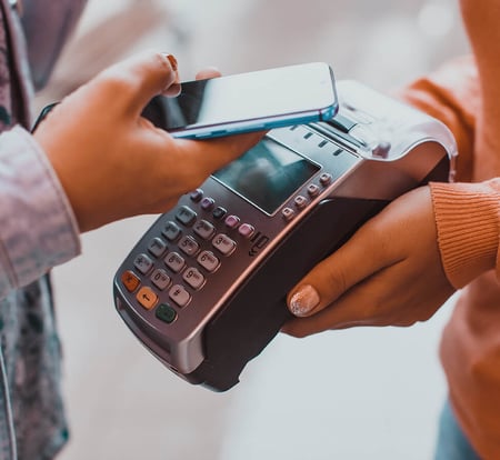 A woman making a purchase with her phone