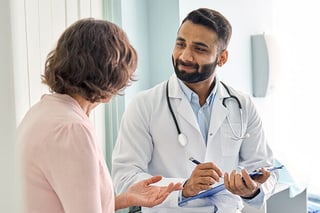 A woman consults with her physician.