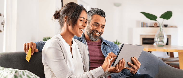 A happy couple shops online.