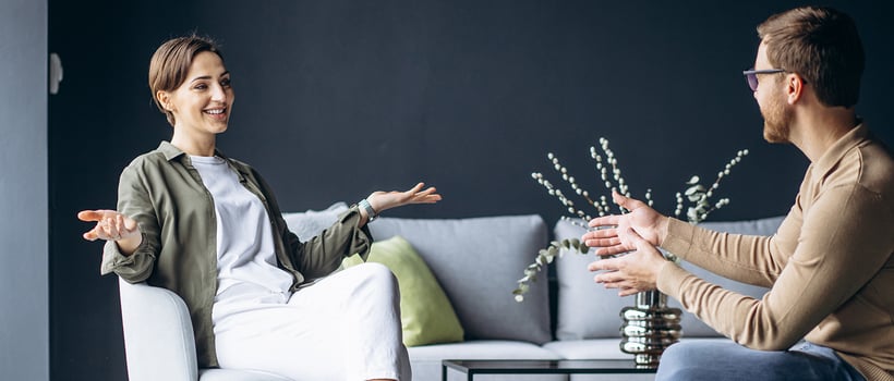 A young couple discusses purchasing a furniture set.