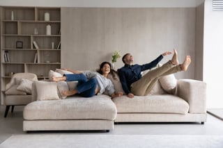 A young couple enjoying their new couch. 